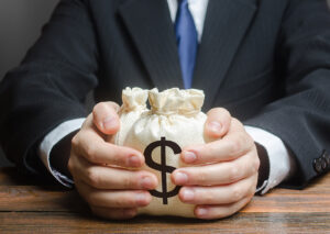 SGP Credit - Personal Loan With Low Interest Rate | Businessman hugs US dollar money bags. Bank deposit. Budget management, tax collection. Trade, economics. Granting financing business project or education. Provision financial loan credit. Corruption