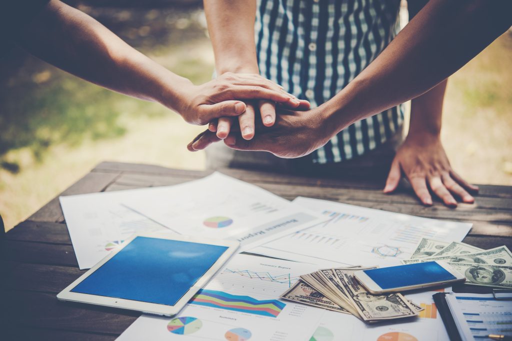 business people making pile hands for their startup
