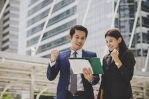 SGP Credit - Personal Loan With Low Interest Rate | Business colleague talking and viewing documents outdoor