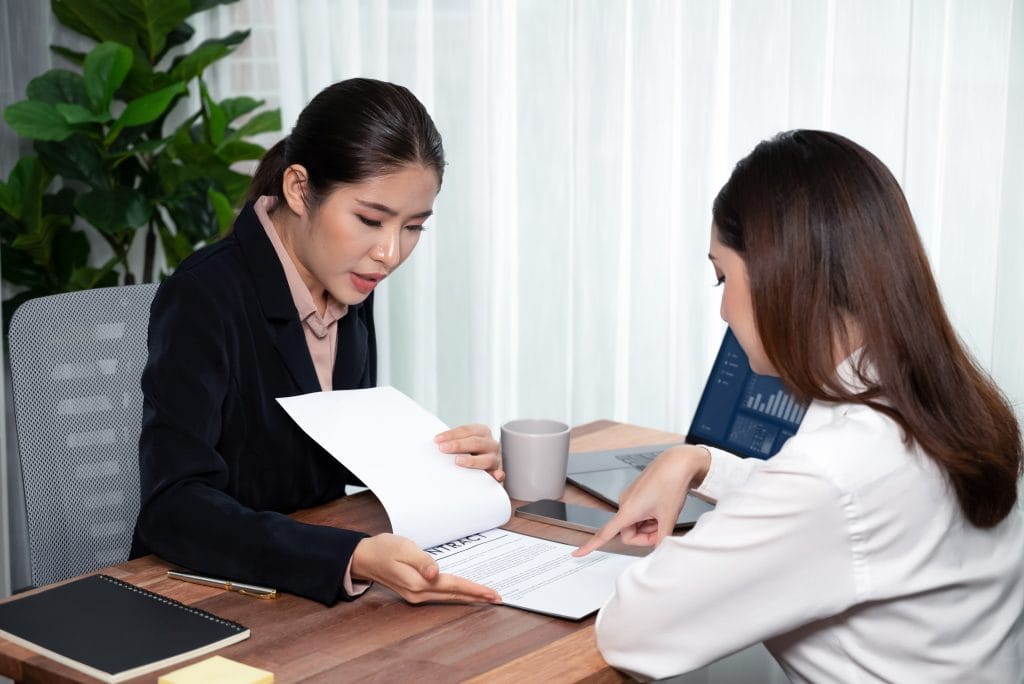 Business deal meeting businesswomen reviewing terms and condition Equilibrium
