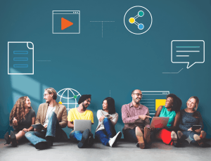 Group of diverse young professionals sitting in a row, smiling and using laptops and tablets against a blue tech-themed background.